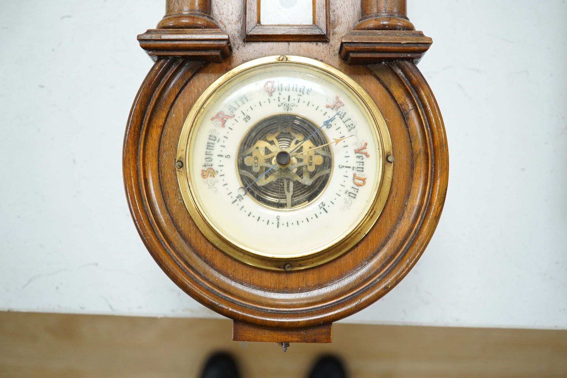 A late 19th century walnut wall clock, barometer and thermometer combination, striking on a coiled gong, 65cm high. Condition - fair, crack to the case and finial missing to the bottom